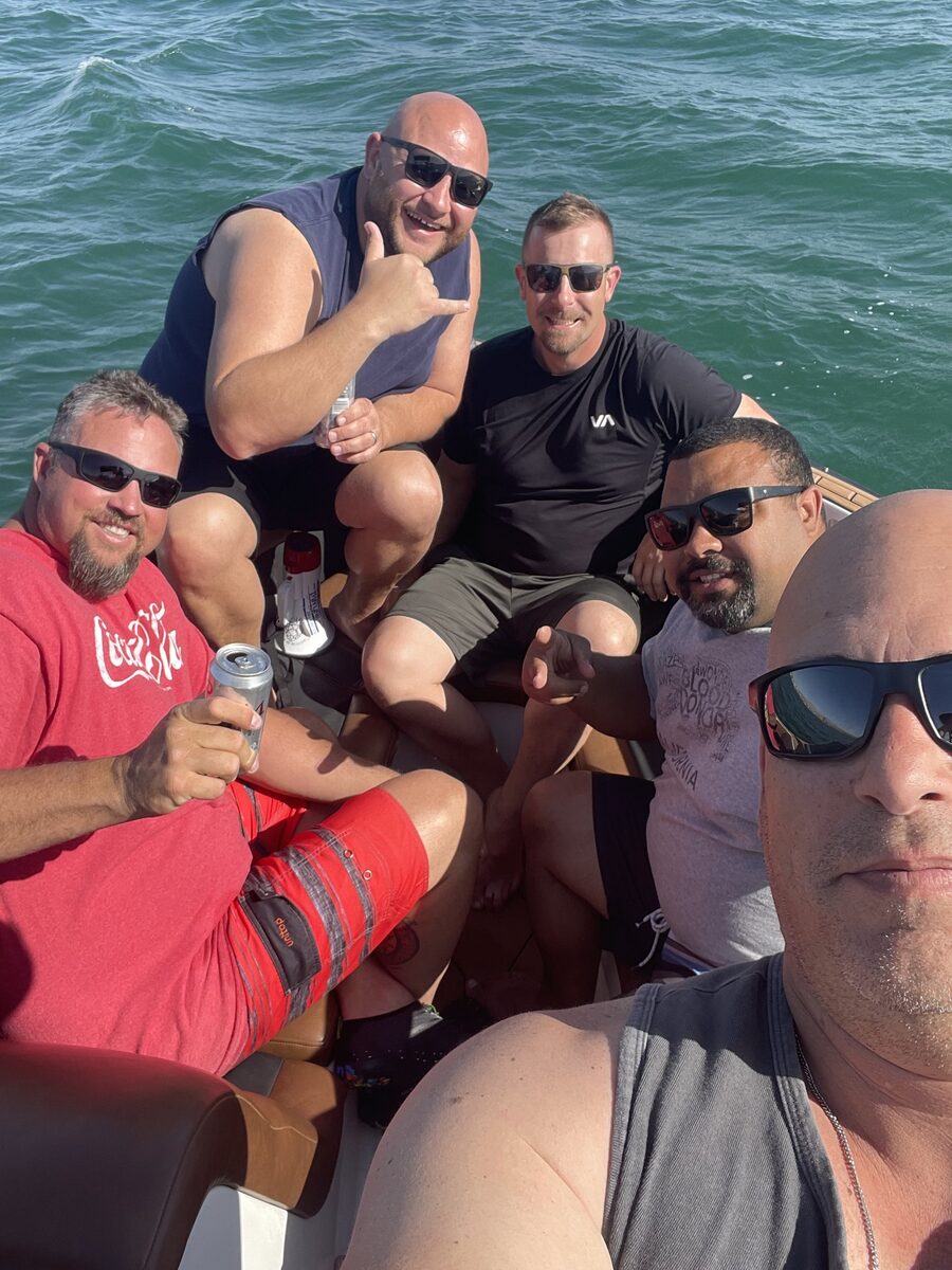 Six men on a boat during guys trip