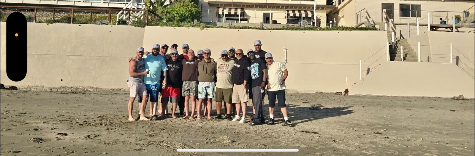 Full crew, full lineup on the beach in matching Guys Trip caps