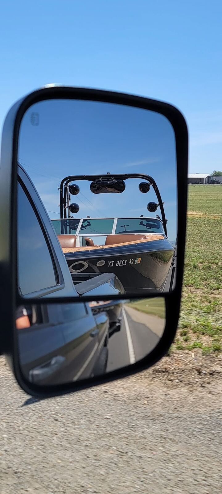 Boat in the side mirror on the way out — California 1236 ZY, miles to go