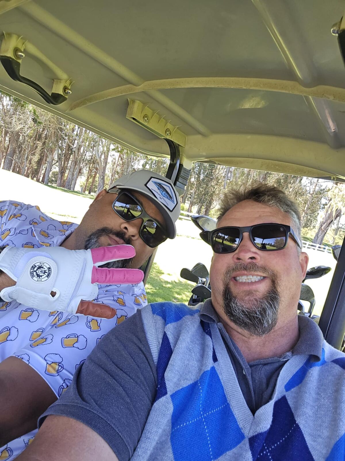 Cart selfie with the beer-mug polo and pink golf glove