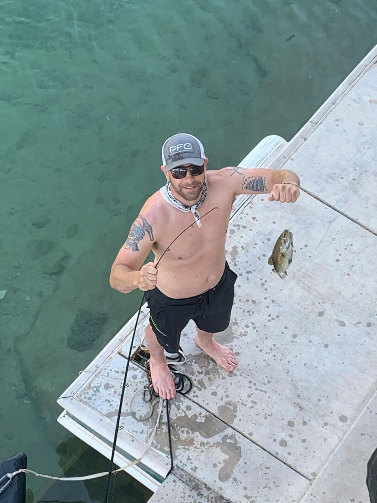 Smallmouth bass on the line — looking up from the dock