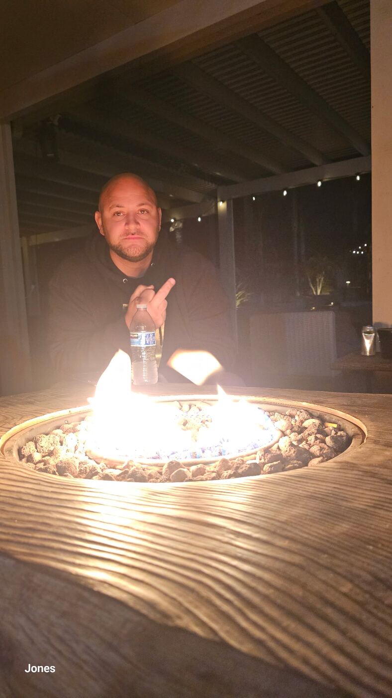 Firepit close-up — flames up, the night settling in