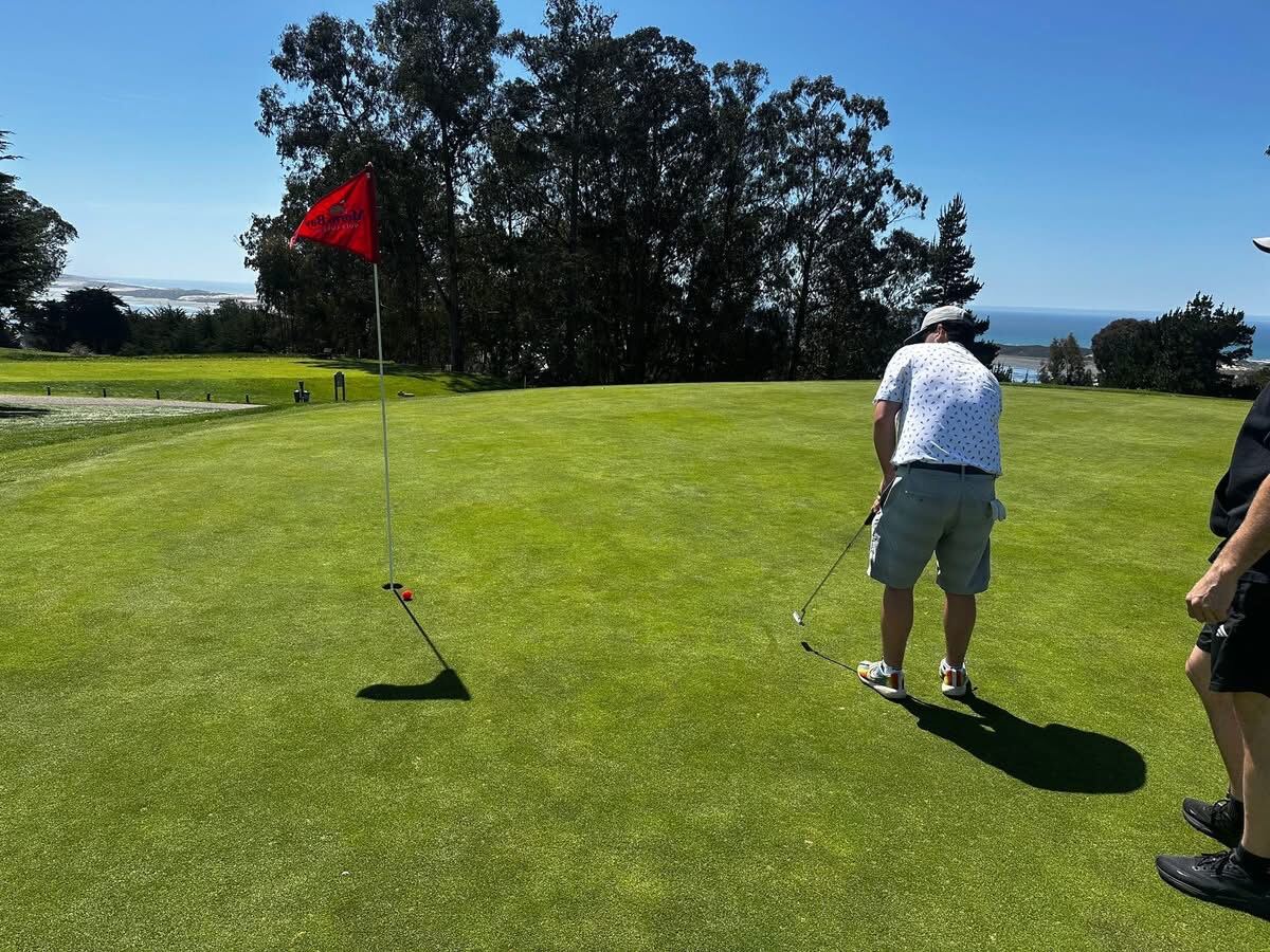Lining up the putt with the Pacific over the back of the green