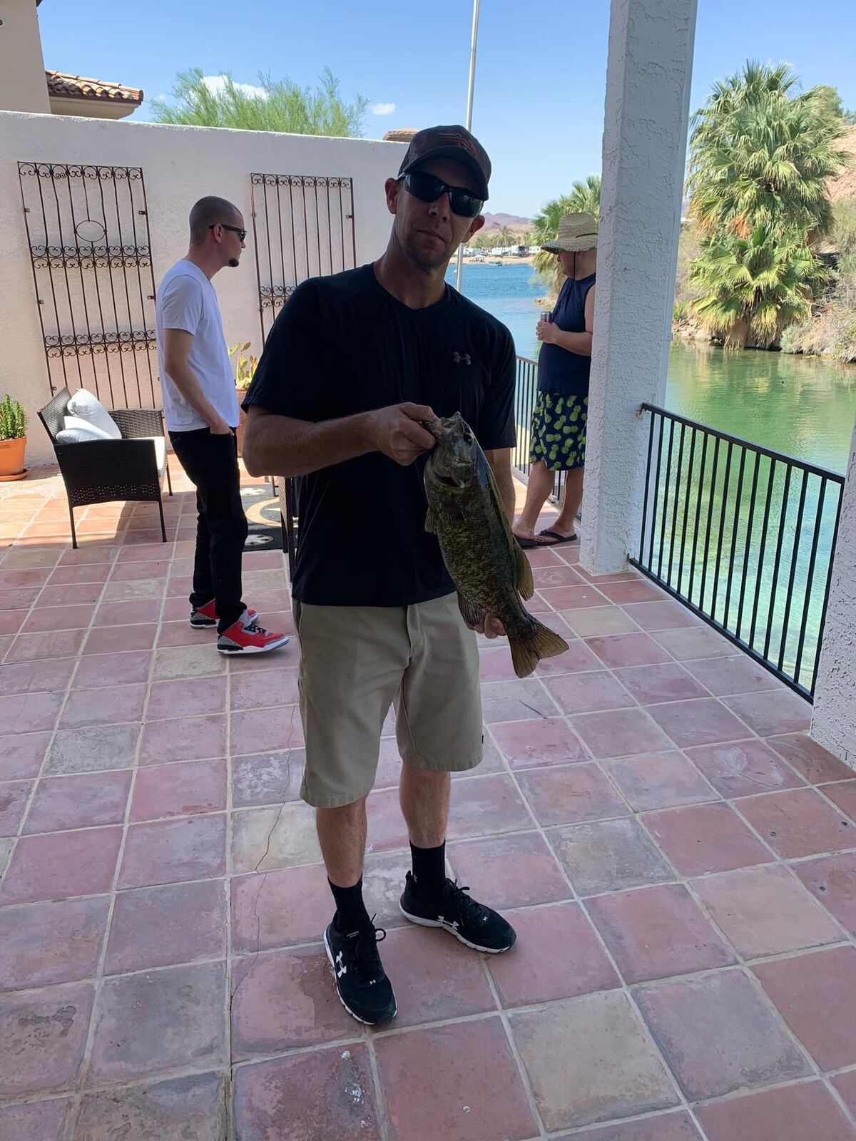 Holding up the big bass on the river patio in Parker