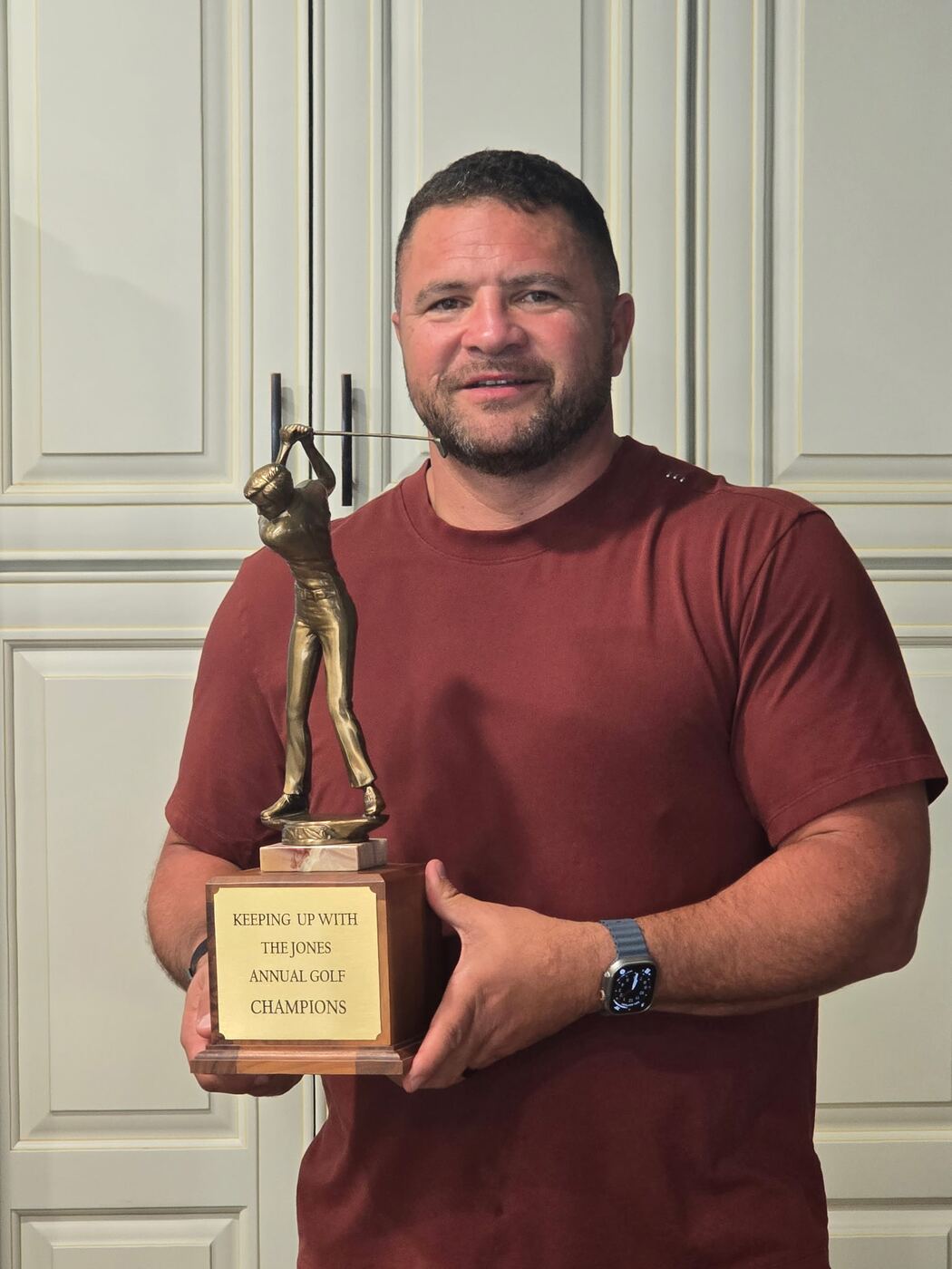 Hoisting the Jones Annual Golf Champions trophy