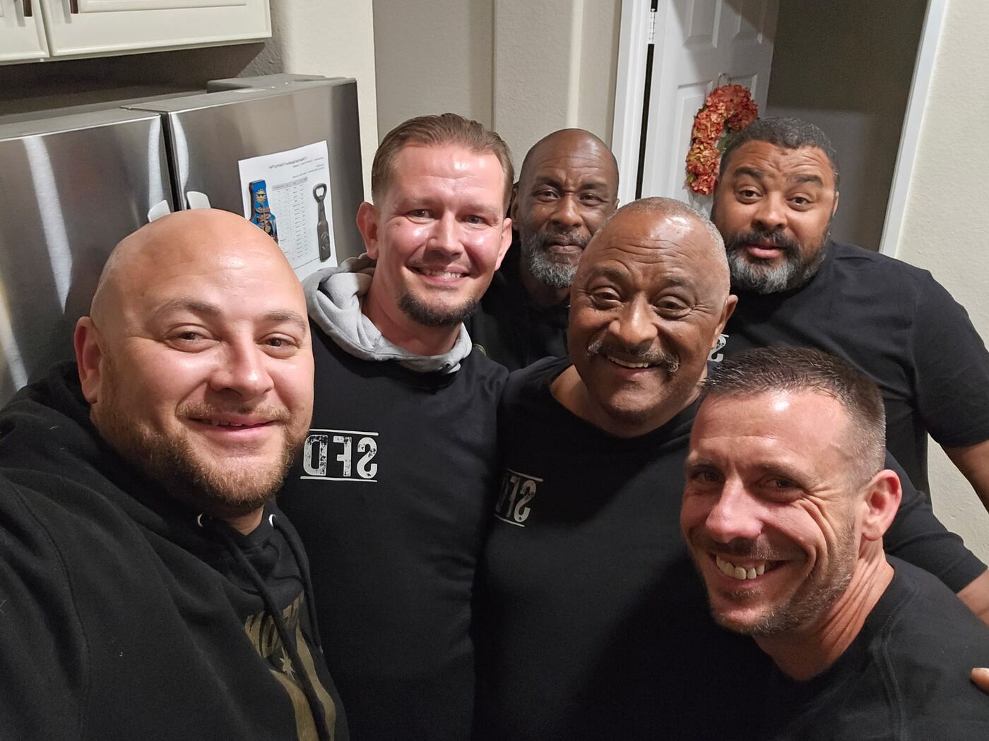 Six brothers in the kitchen, SFD shirts, full grins
