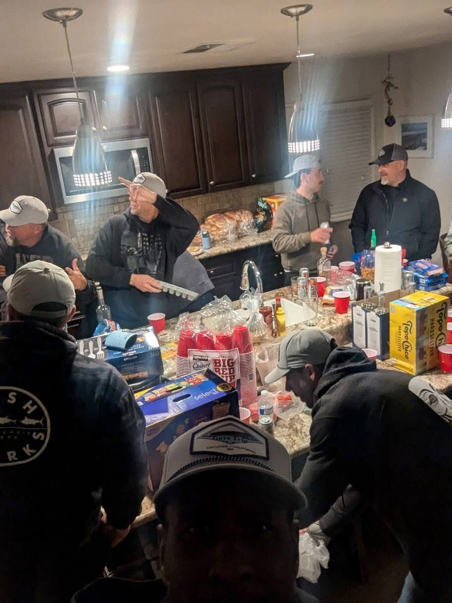 Wide kitchen shot — beer fridge, snacks, brothers, full house