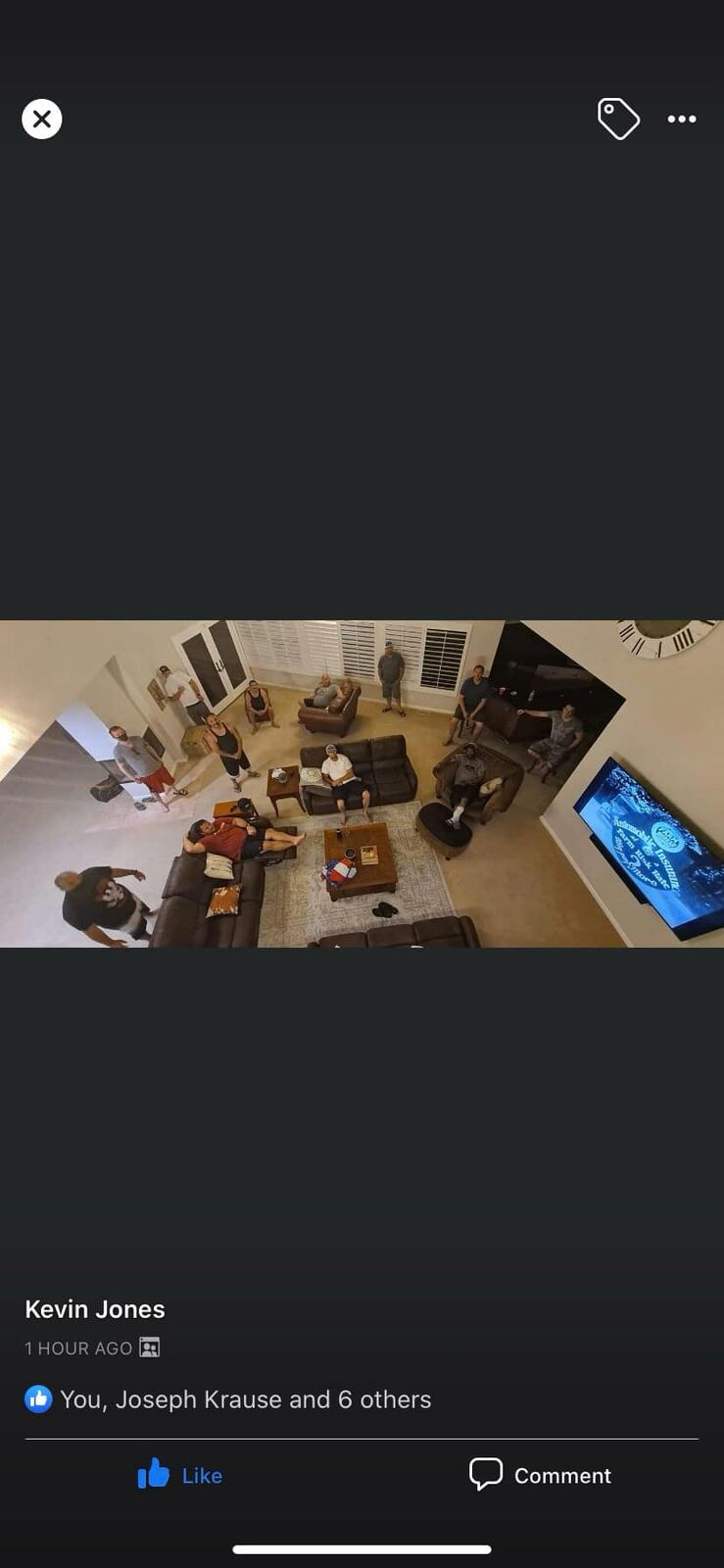Aerial view of the great room — whole crew spread across the couches