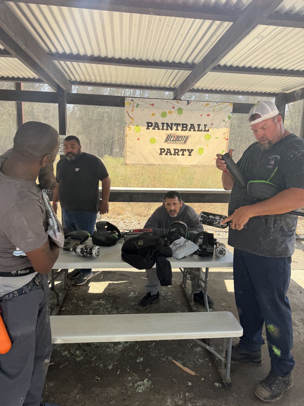 Velocity Paintball Party banner — gearing up at the table