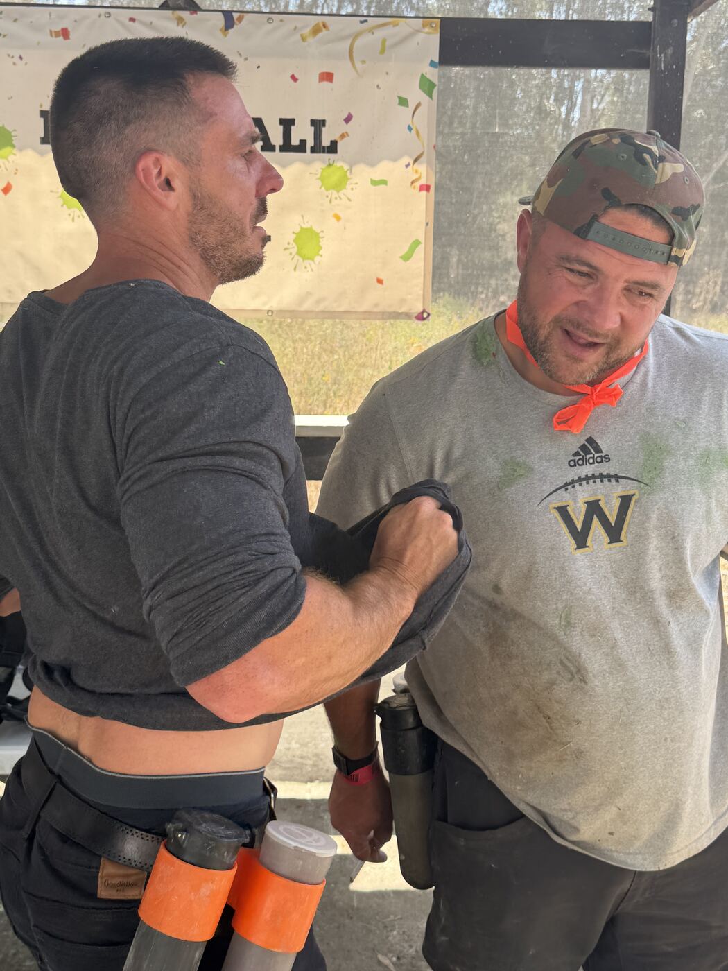 Strapping in before the paintball match — game faces on