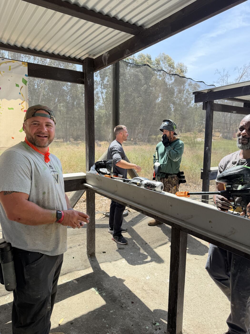 Loading up at the shelter — markers, hoppers and game faces