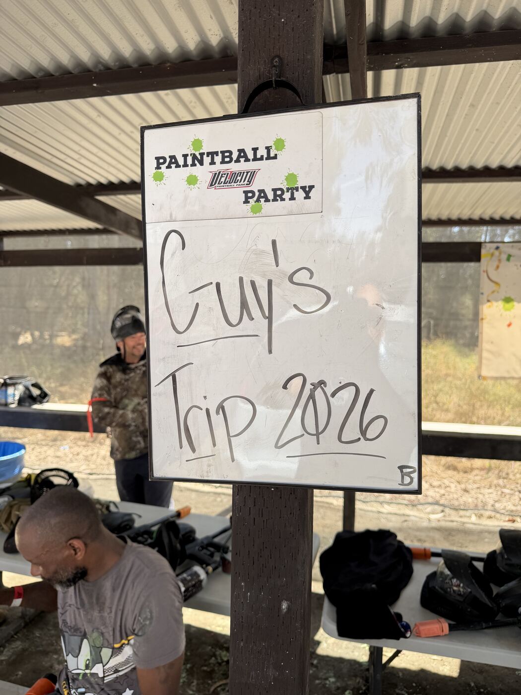 'Guy's Trip 2026' whiteboard at the paintball park — claiming the field