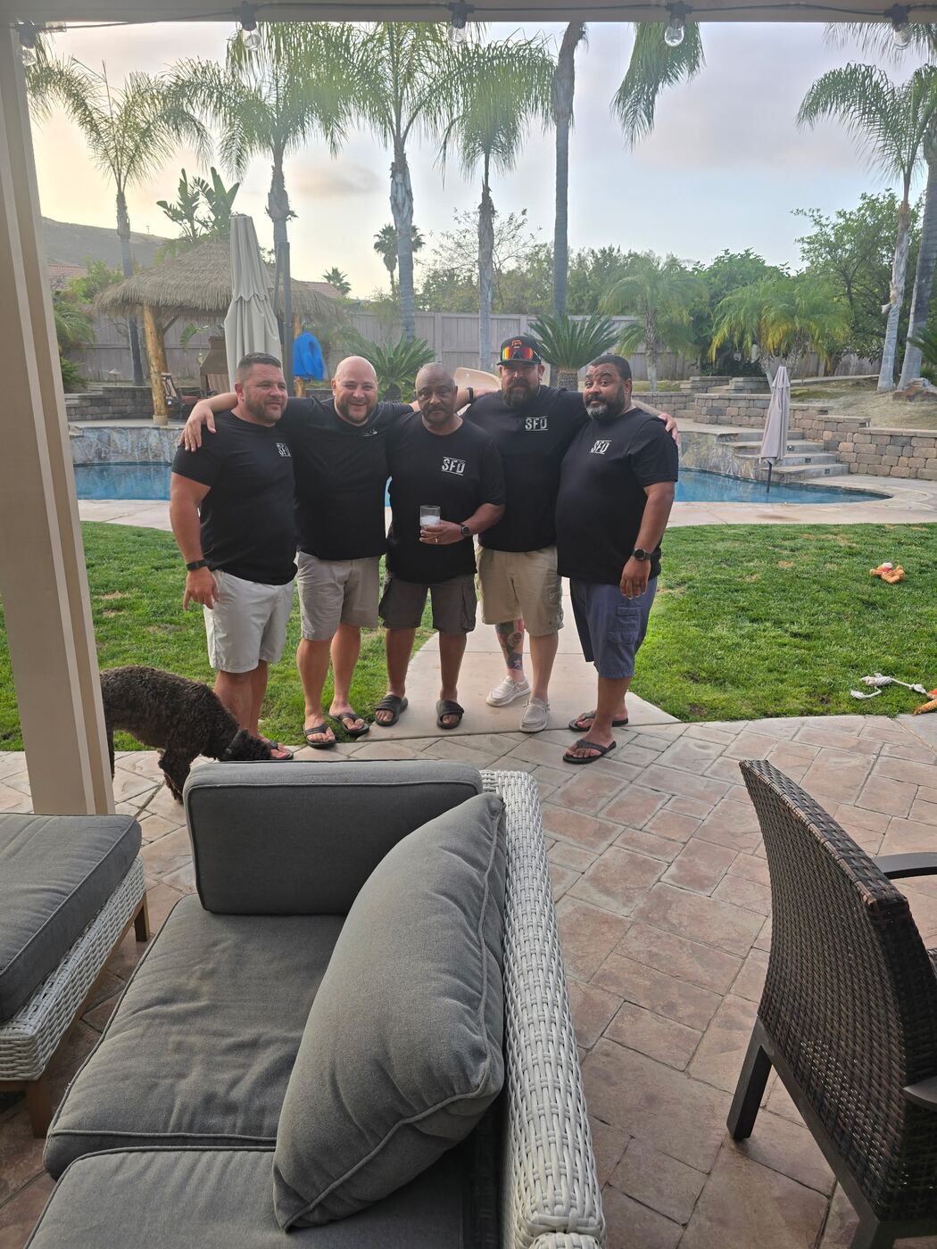 Poolside lineup at golden hour — matching SFD tees, full hearts