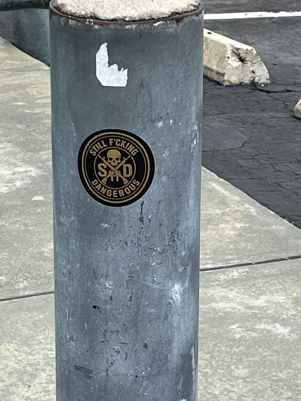SFD sticker stuck to a sidewalk bollard — stickers in the wild