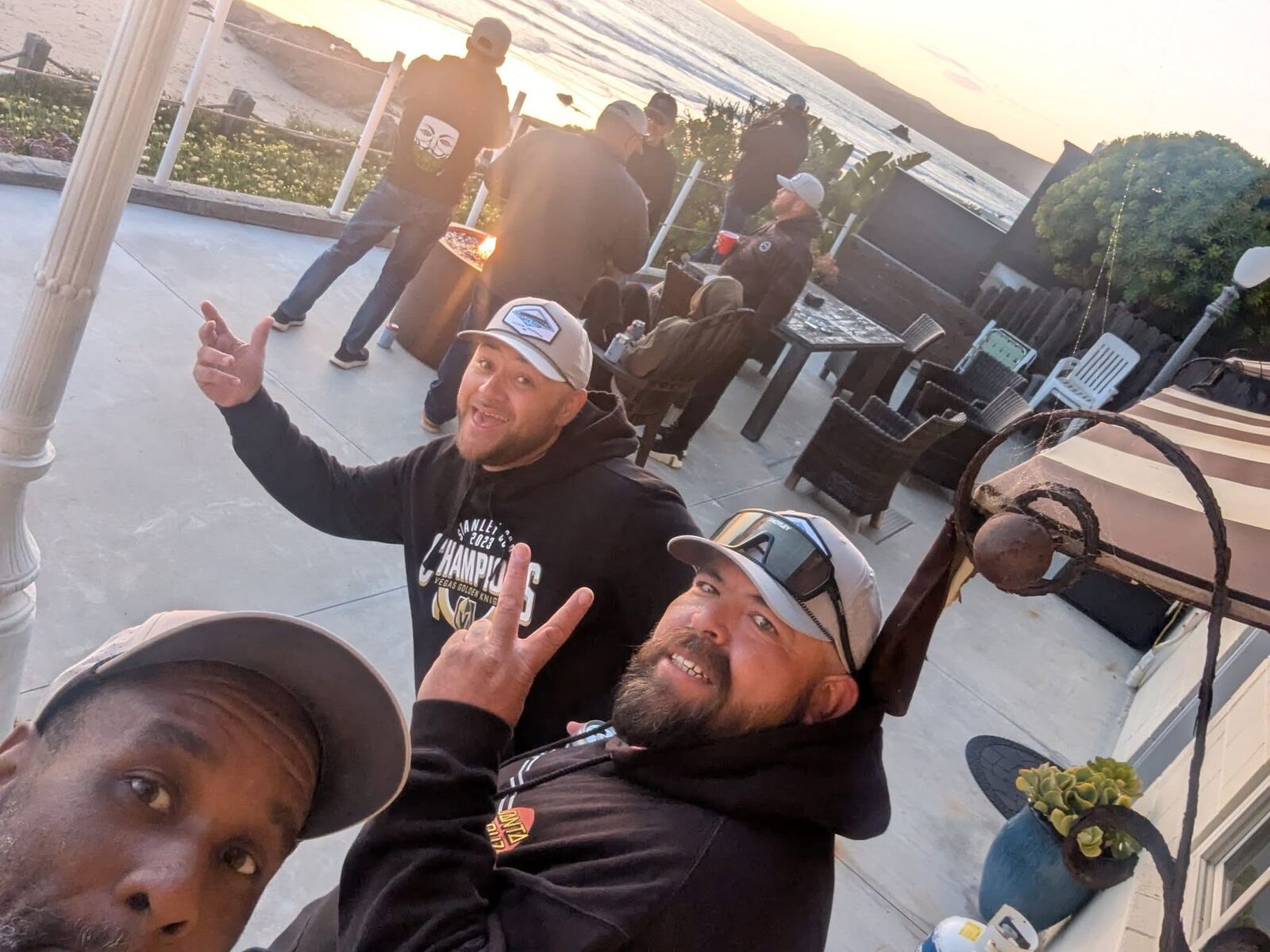 Patio selfie at sunset over the Pacific — Champions hoodie energy