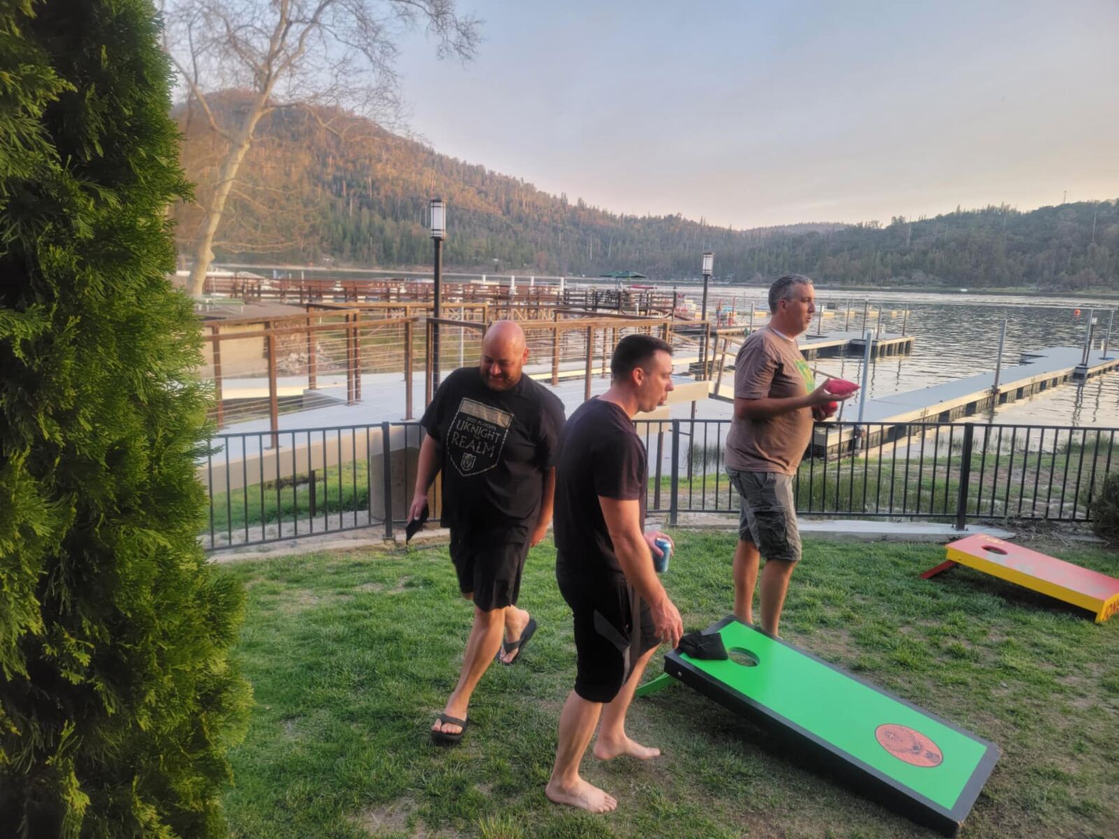 Cornhole on the lawn at Big Bear Lake, dock in the background