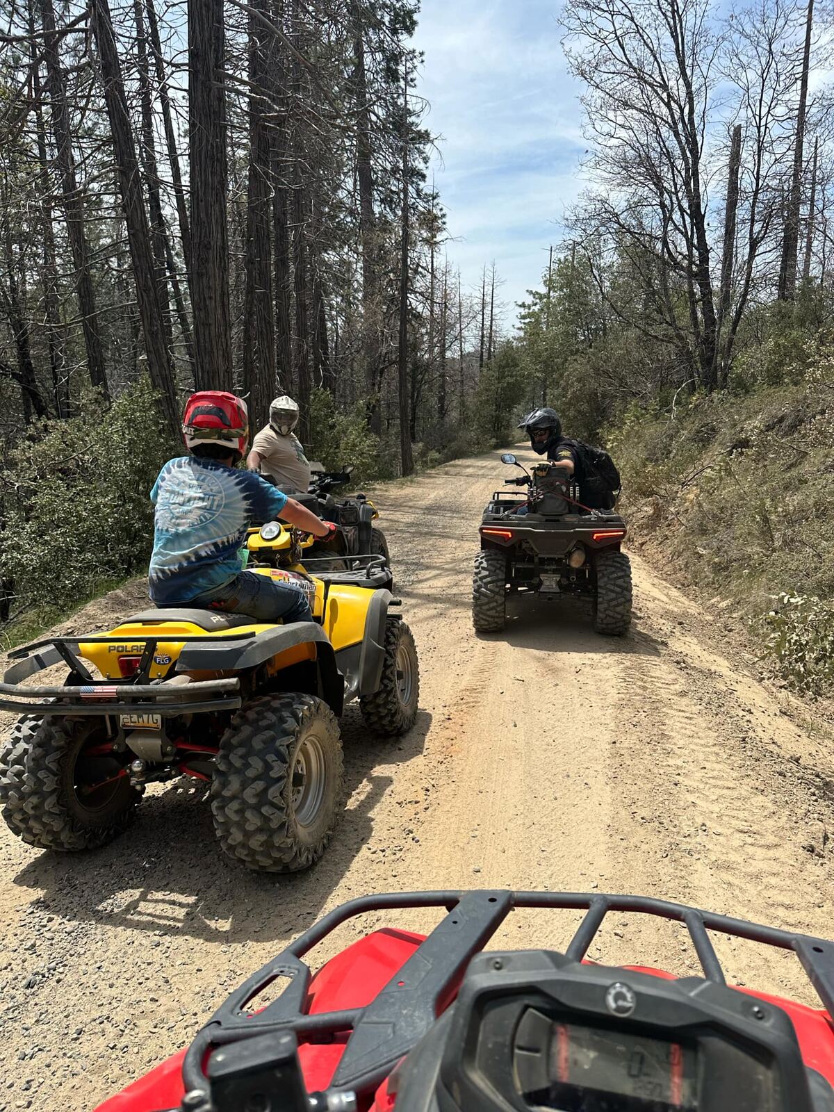 ATV convoy rolling deep down the fire road through the burn